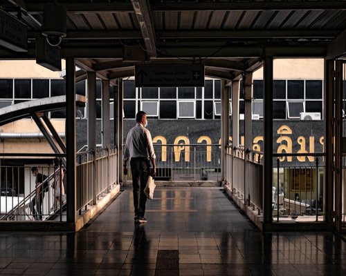 person waiting for BTS train in Bangkok during rush hour
