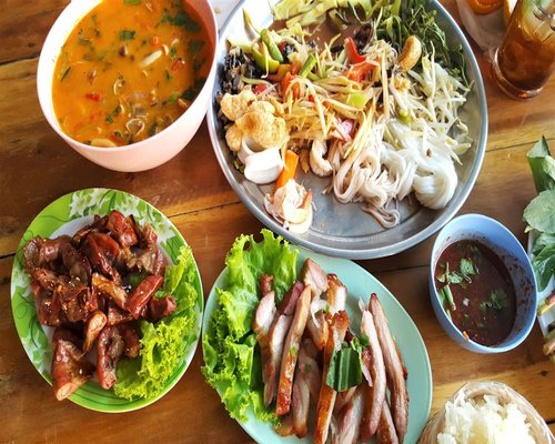 family sharing a simple home cooked meal in Thailand
